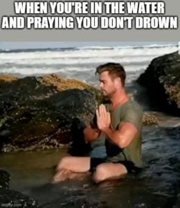 image of a man praying at the beach